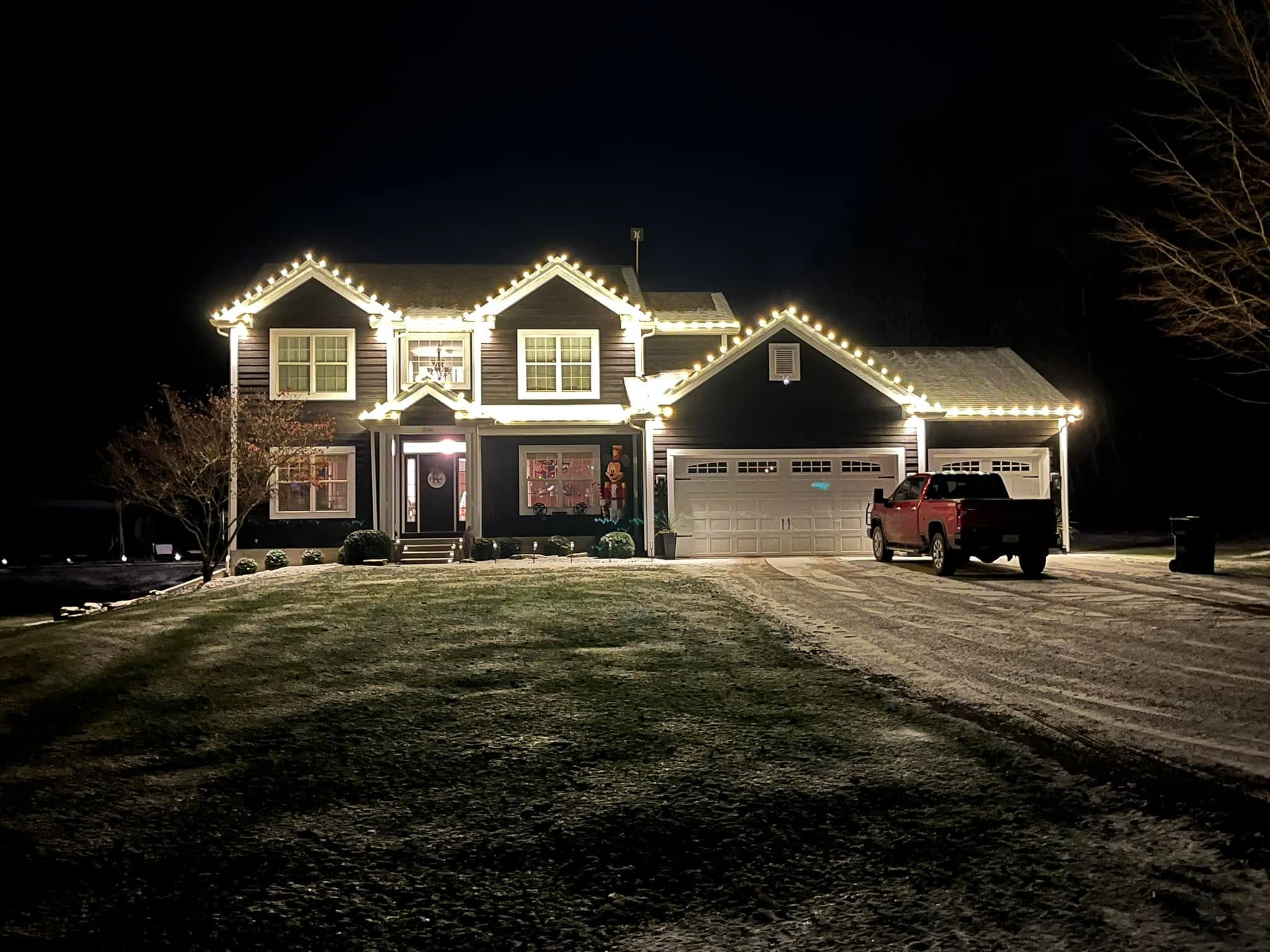 Home lit with warm white C9 bulbs on a snowy winter evening